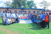 Group photo of YCFCU members holding large signs on the training.